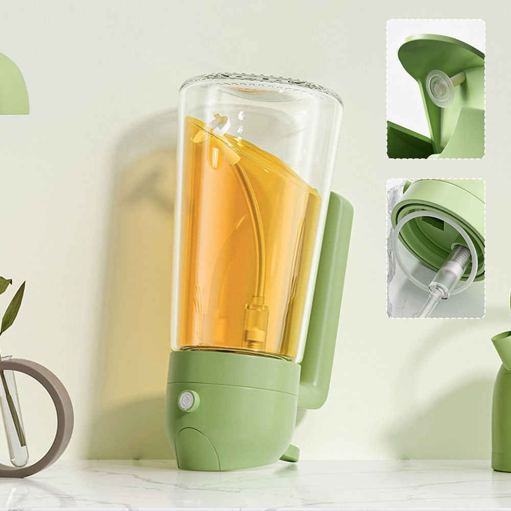 Green portable blender with a clear container filled with orange liquid on a light background.