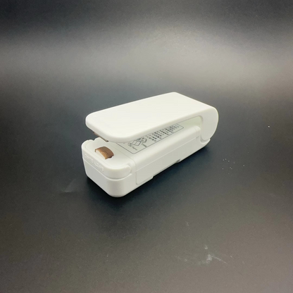 White stapler on a dark gray background