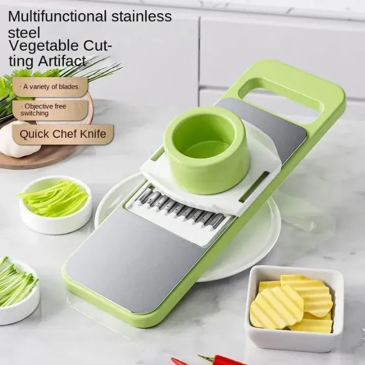 Multifunctional stainless steel vegetable cutting artifact with green and gray design on a kitchen counter.