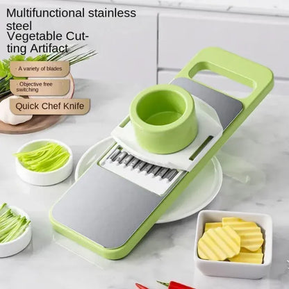 Multifunctional stainless steel vegetable cutting artifact with green and gray design on a kitchen counter.