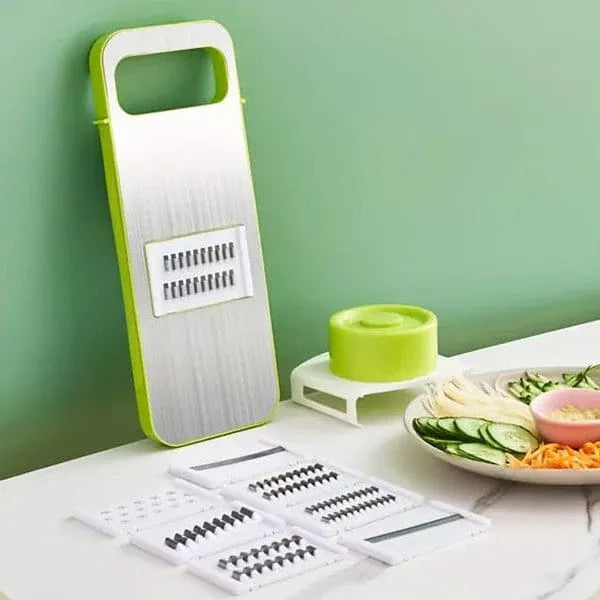 Green and white mandoline slicer with adjustable blades on a light green background